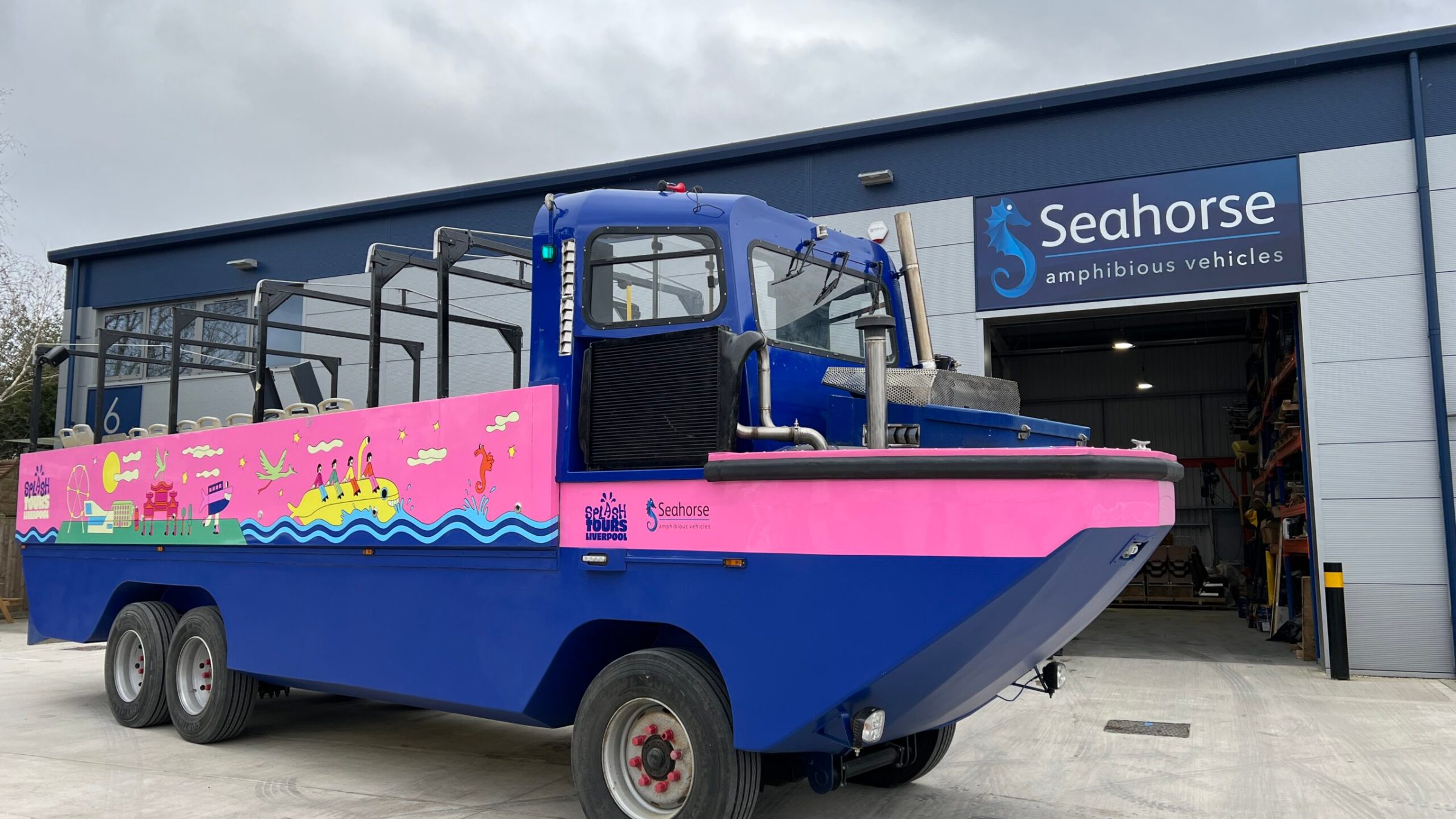 a blue truck parked in front of a building
