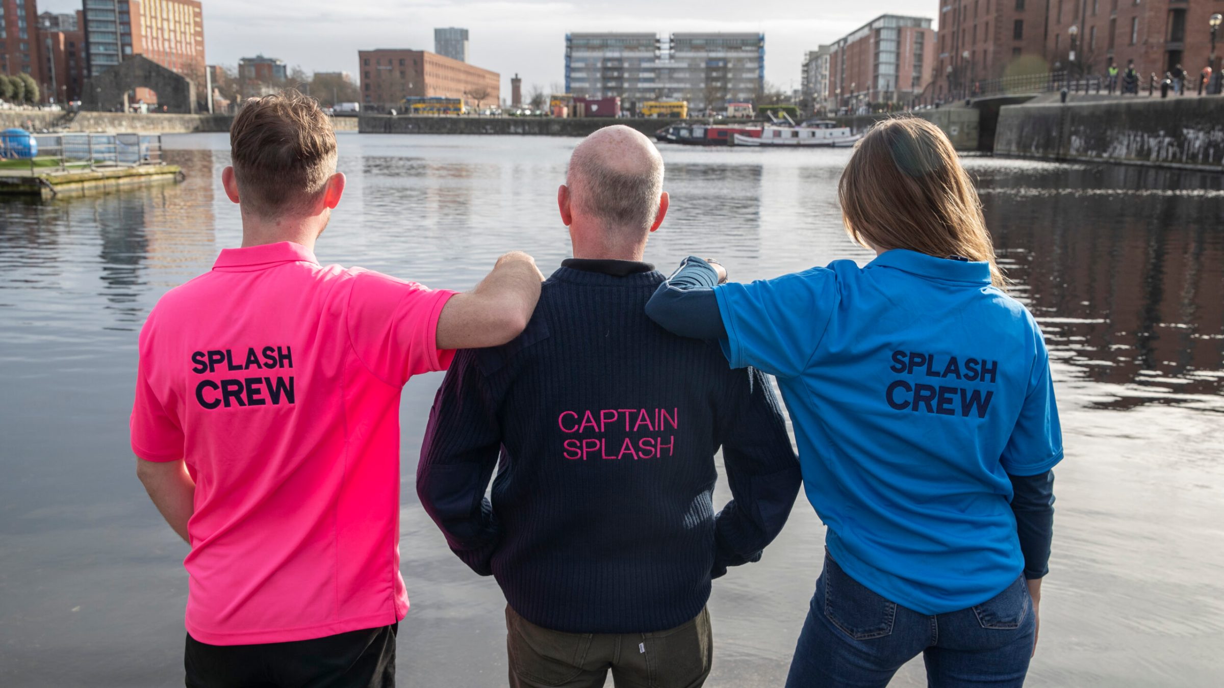 a man standing next to a body of water