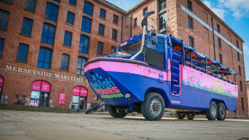 a blue truck parked in front of a brick building