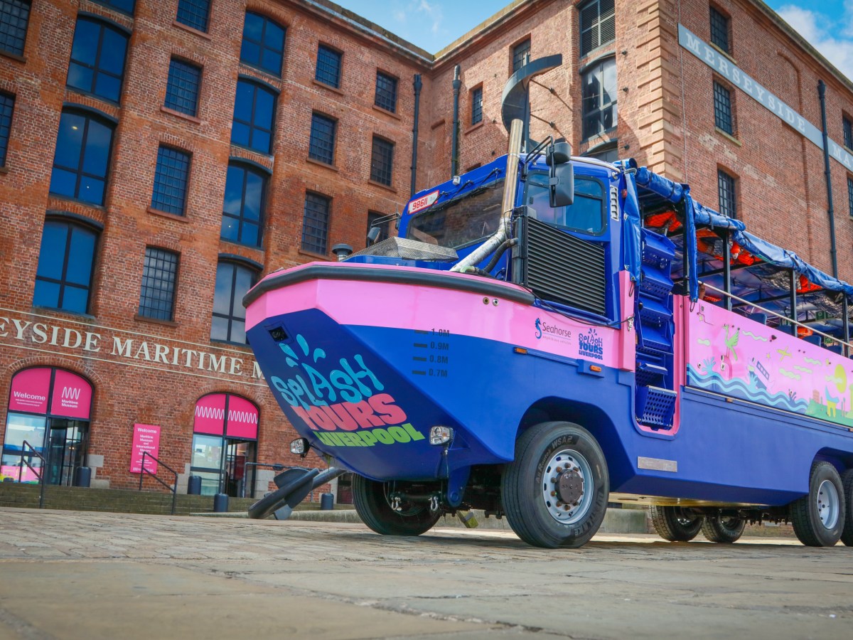 a blue truck parked in front of a brick building